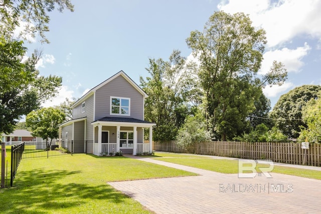 rear view of property featuring a yard and a porch