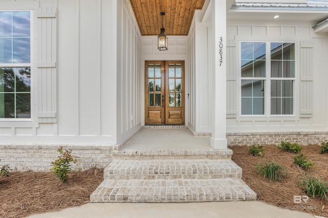 entrance to property featuring board and batten siding and french doors