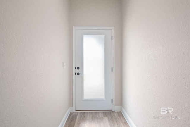 doorway with light wood-type flooring