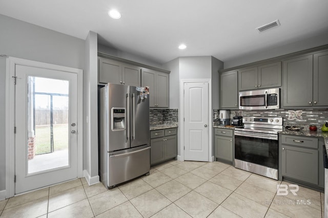 1206 Crown Walk Dr, Foley, AL 36535 - kitchen featuring appliances with stainless steel finishes, dark stone counters, and gray cabinetry
