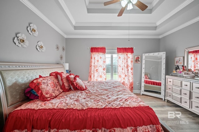 1206 Crown Walk Dr, Foley, AL 36535 - bedroom featuring crown molding, ceiling fan, a raised ceiling, and light wood-type flooring