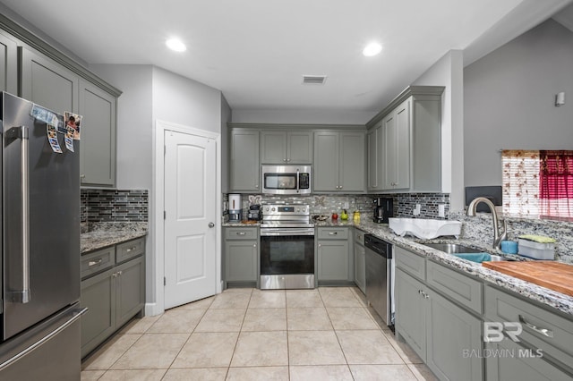 1206 Crown Walk Dr, Foley, AL 36535 - kitchen featuring light stone counters, sink, gray cabinets, and stainless steel appliances