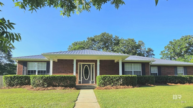 22054 S Stoddard St, Robertsdale, AL 36567 - ranch-style house with brick siding, a front yard, and metal roof