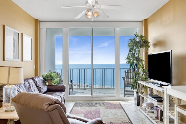 living room with light tile patterned flooring and a ceiling fan