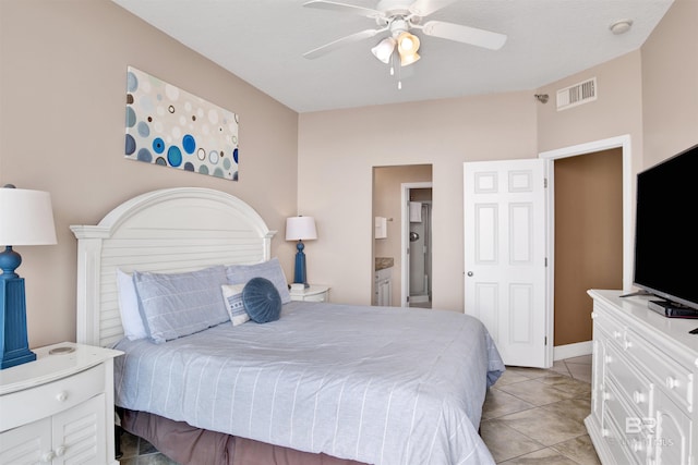 bedroom featuring ensuite bath, visible vents, ceiling fan, and light tile patterned floors