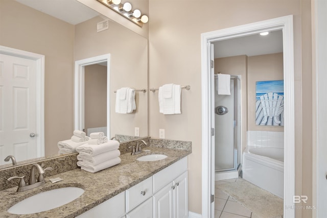 full bath with a shower stall, tile patterned floors, a bath, and a sink