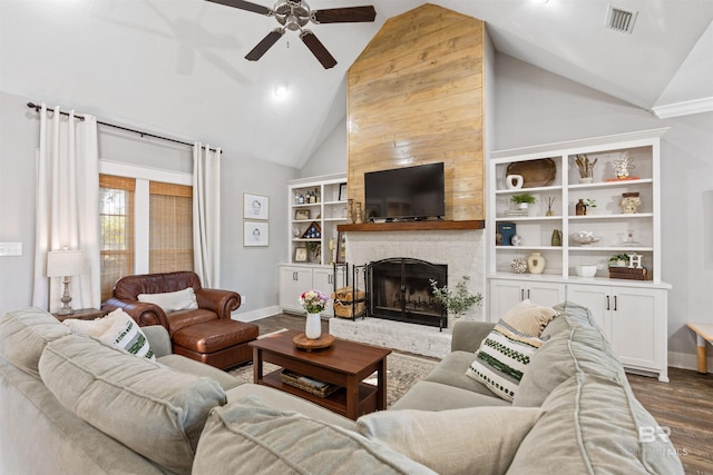 living room with ceiling fan, dark wood-type flooring, lofted ceiling, and a fireplace