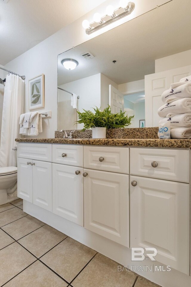 401 E Beach Blvd Unit 1302, Gulf Shores, AL 36542 - full bathroom with toilet, tile patterned floors, vanity, and visible vents