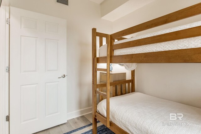 401 E Beach Blvd Unit 1302, Gulf Shores, AL 36542 - bedroom featuring wood finished floors, baseboards, and visible vents