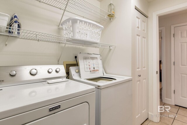 401 E Beach Blvd Unit 1302, Gulf Shores, AL 36542 - laundry room with light tile patterned floors, washing machine and dryer, and laundry area