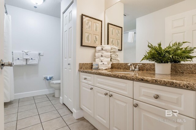 401 E Beach Blvd Unit 1302, Gulf Shores, AL 36542 - full bathroom with vanity, a closet, baseboards, tile patterned flooring, and toilet