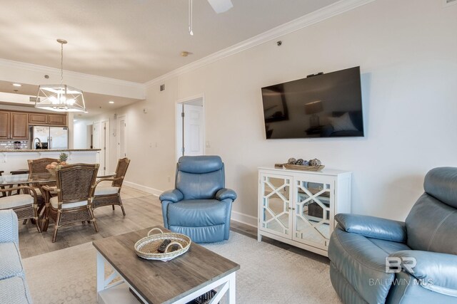 401 E Beach Blvd Unit 1302, Gulf Shores, AL 36542 - living room with crown molding, ceiling fan with notable chandelier, light wood-type flooring, recessed lighting, and baseboards