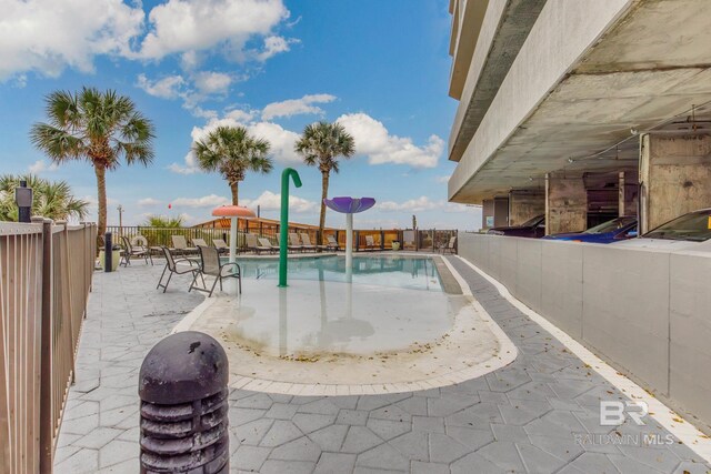 401 E Beach Blvd Unit 1302, Gulf Shores, AL 36542 - community pool featuring a patio and fence