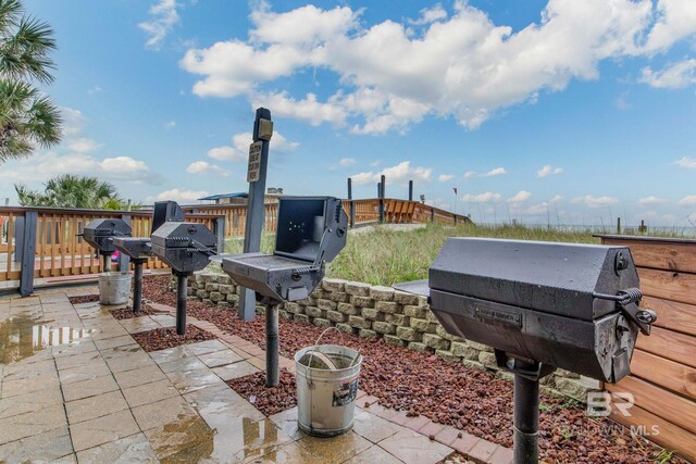 401 E Beach Blvd Unit 1302, Gulf Shores, AL 36542 - view of patio / terrace with grilling area and fence