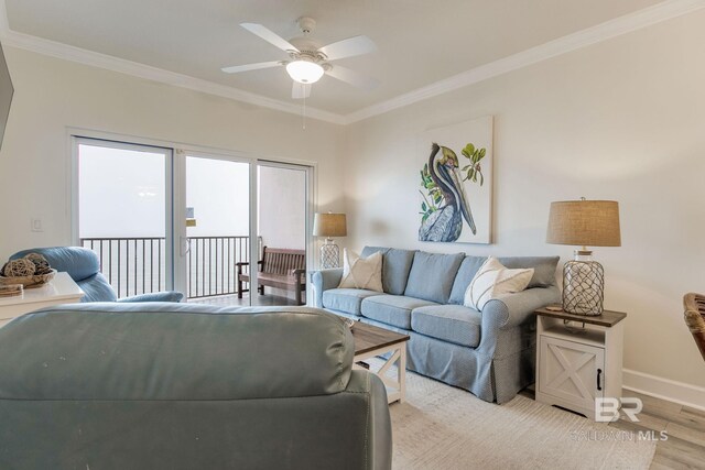 401 E Beach Blvd Unit 1302, Gulf Shores, AL 36542 - living room with crown molding, ceiling fan, baseboards, and light wood-style floors