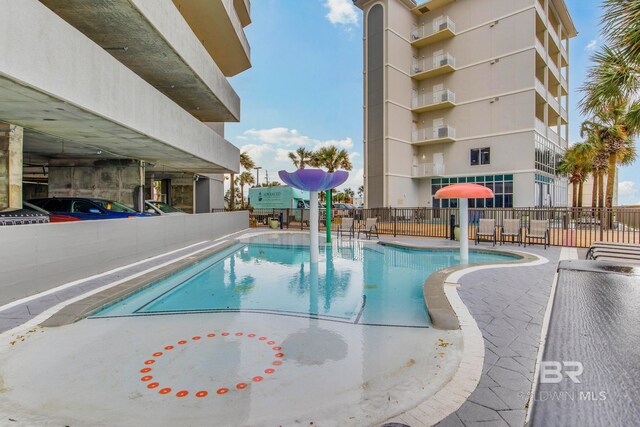 401 E Beach Blvd Unit 1302, Gulf Shores, AL 36542 - pool featuring a water play area and fence