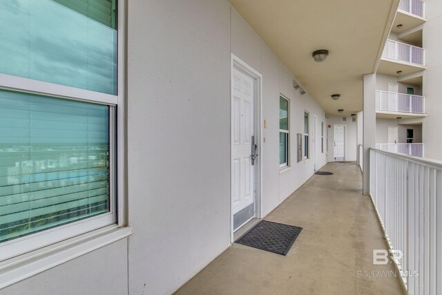 401 E Beach Blvd Unit 1302, Gulf Shores, AL 36542 - view of exterior entry featuring stucco siding and visible vents