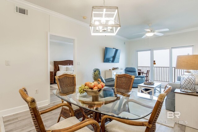 401 E Beach Blvd Unit 1302, Gulf Shores, AL 36542 - dining space with visible vents, baseboards, ornamental molding, ceiling fan, and light wood-style floors