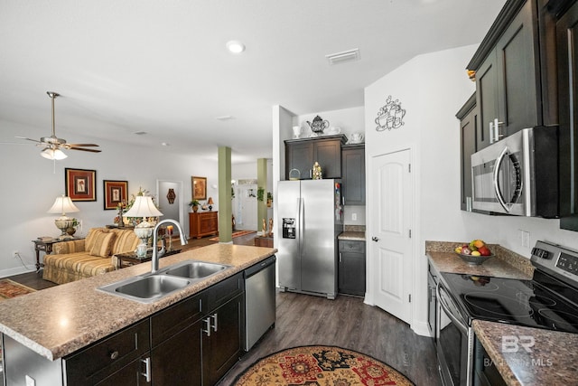 23038 Ridgewood Dr, Robertsdale, AL 36567 - kitchen with stainless steel appliances, a sink, a kitchen island with sink, dark wood-style floors, and open floor plan