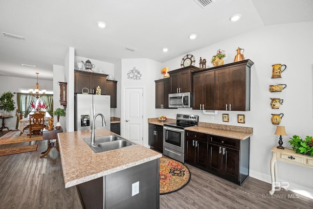 23038 Ridgewood Dr, Robertsdale, AL 36567 - kitchen featuring appliances with stainless steel finishes, a sink, a chandelier, dark brown cabinetry, and recessed lighting