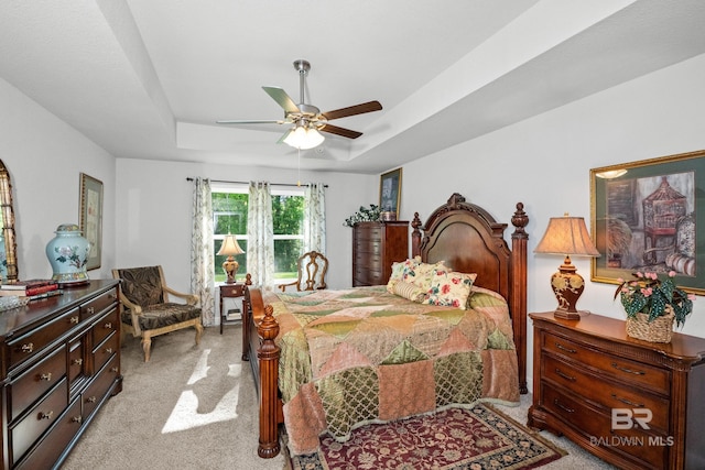 23038 Ridgewood Dr, Robertsdale, AL 36567 - bedroom featuring light colored carpet, a tray ceiling, and ceiling fan