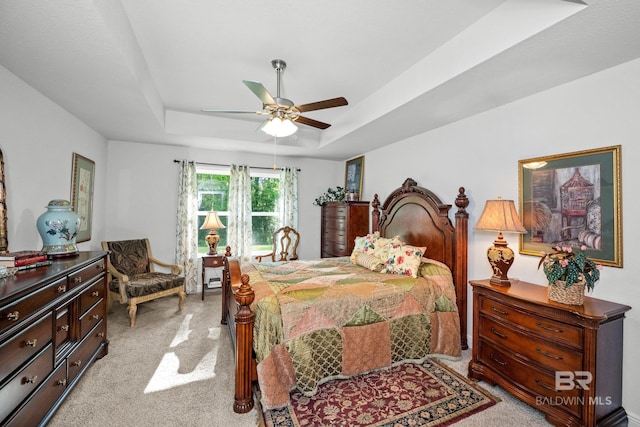 23038 Ridgewood Dr, Robertsdale, AL 36567 - bedroom featuring light carpet, a tray ceiling, and a ceiling fan