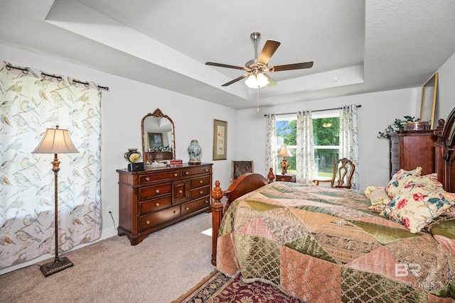 23038 Ridgewood Dr, Robertsdale, AL 36567 - carpeted bedroom with a raised ceiling and a ceiling fan