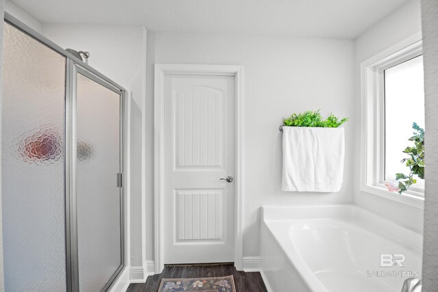 23038 Ridgewood Dr, Robertsdale, AL 36567 - full bath featuring a stall shower, a bath, and wood finished floors