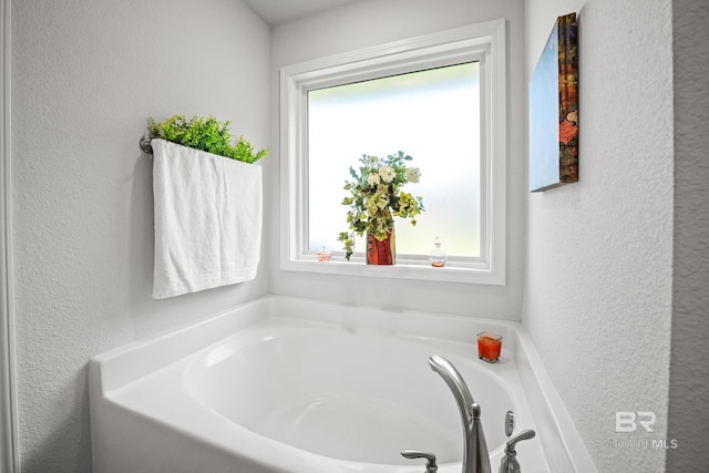 23038 Ridgewood Dr, Robertsdale, AL 36567 - bathroom featuring healthy amount of natural light, a garden tub, and a textured wall