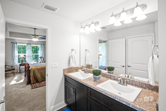 23038 Ridgewood Dr, Robertsdale, AL 36567 - full bath featuring ensuite bath, double vanity, baseboards, and a ceiling fan