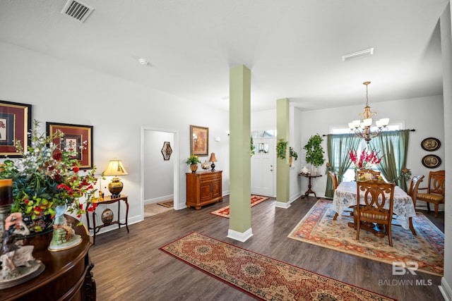 23038 Ridgewood Dr, Robertsdale, AL 36567 - dining area with a chandelier, wood finished floors, and baseboards