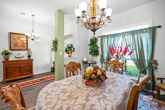 23038 Ridgewood Dr, Robertsdale, AL 36567 - dining space featuring a chandelier, wood finished floors, plenty of natural light, and baseboards