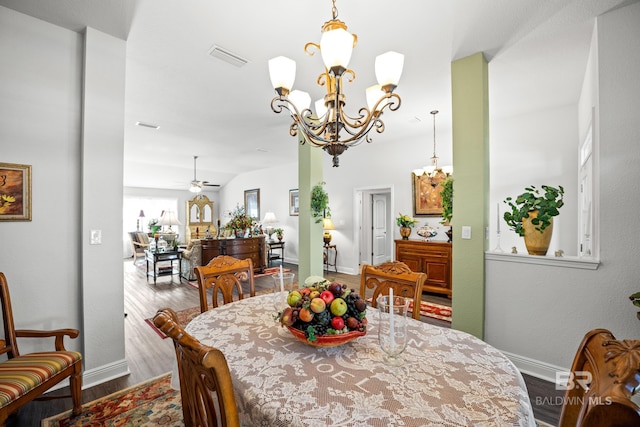 23038 Ridgewood Dr, Robertsdale, AL 36567 - dining area with a chandelier, wood finished floors, baseboards, and ceiling fan
