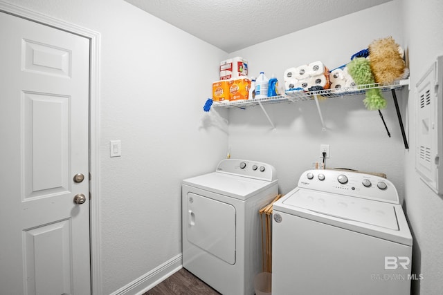 23038 Ridgewood Dr, Robertsdale, AL 36567 - washroom featuring washing machine and clothes dryer, dark wood-type flooring, baseboards, and a textured ceiling