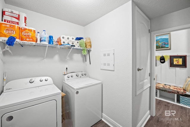 23038 Ridgewood Dr, Robertsdale, AL 36567 - washroom featuring washer and clothes dryer, dark wood-style flooring, a textured ceiling, and baseboards