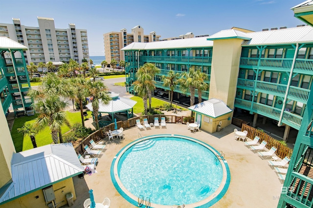 pool featuring fence and a patio