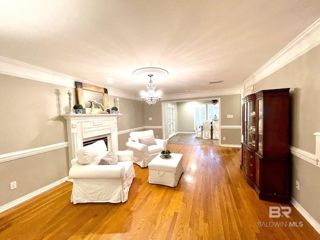 1203 Captain Oneal Dr, Daphne, AL 36526 - living area featuring wood finished floors, a chandelier, crown molding, a fireplace, and baseboards