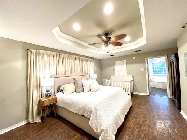 1203 Captain Oneal Dr, Daphne, AL 36526 - bedroom with a raised ceiling, baseboards, dark wood-style floors, and connected bathroom
