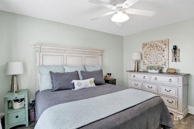 bedroom with wood finished floors and a ceiling fan