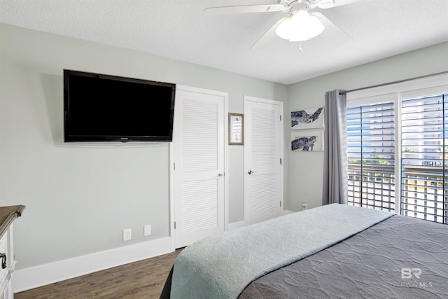 bedroom featuring ceiling fan, baseboards, a textured ceiling, and wood finished floors