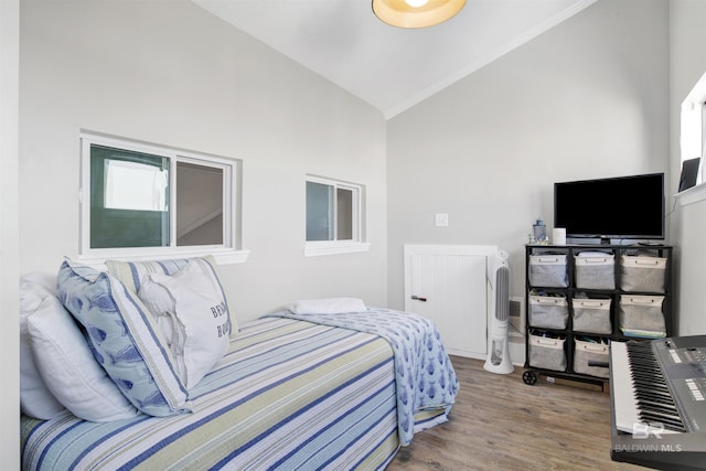 bedroom featuring vaulted ceiling and wood finished floors