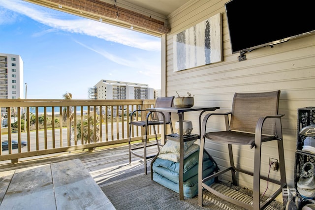 wooden deck with a city view