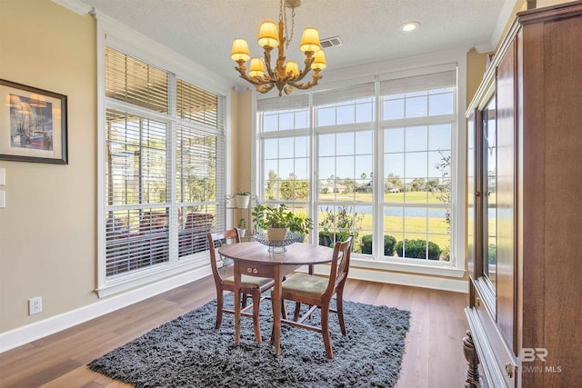 sunroom / solarium with a healthy amount of sunlight and a chandelier