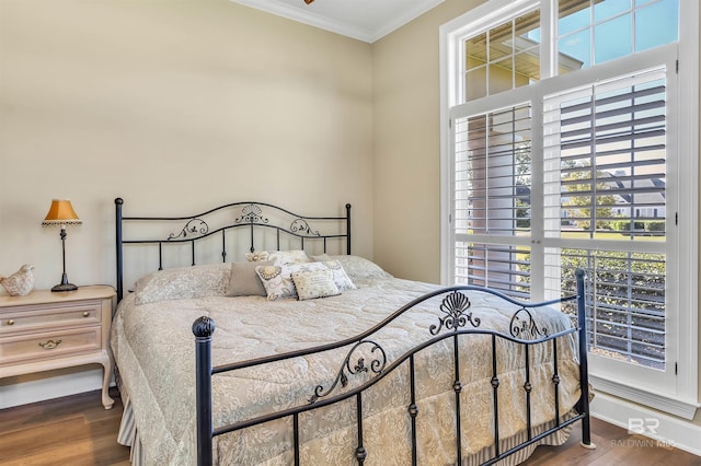 bedroom featuring crown molding and hardwood / wood-style flooring