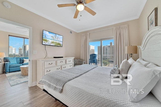 bedroom with light hardwood / wood-style floors, access to outside, multiple windows, and ceiling fan