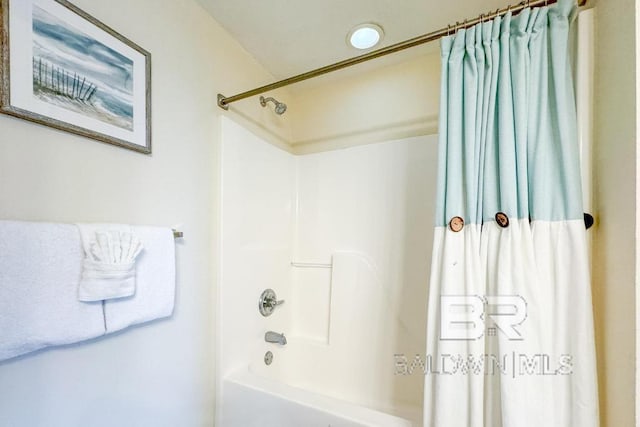 bathroom with shower / tub combo with curtain