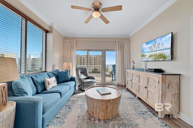 living room with ornamental molding, light hardwood / wood-style flooring, and ceiling fan