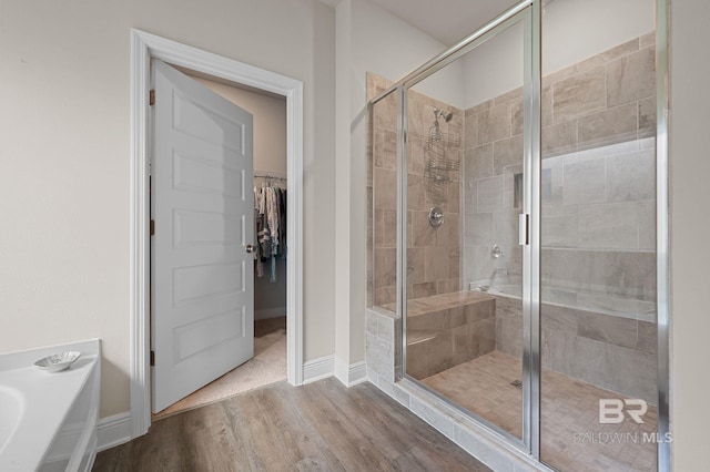 24884 Smarty Jones Cir, Daphne, AL 36526 - bathroom with a shower stall, wood finished floors, a spacious closet, and a bathtub