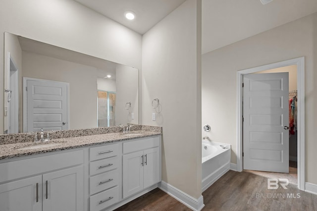 24884 Smarty Jones Cir, Daphne, AL 36526 - full bathroom featuring wood finished floors, double vanity, a garden tub, and a spacious closet