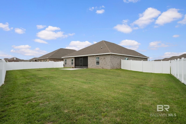 24884 Smarty Jones Cir, Daphne, AL 36526 - back of house with a fenced backyard, a patio area, a sunroom, and brick siding